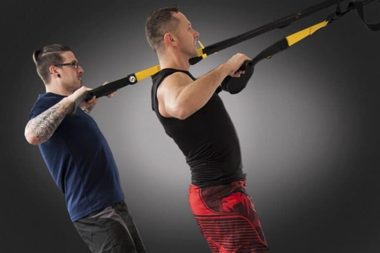 Two men exercising with TRX suspension trainer