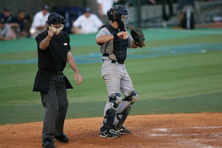 Baseball umpire pointing to indicate a strike