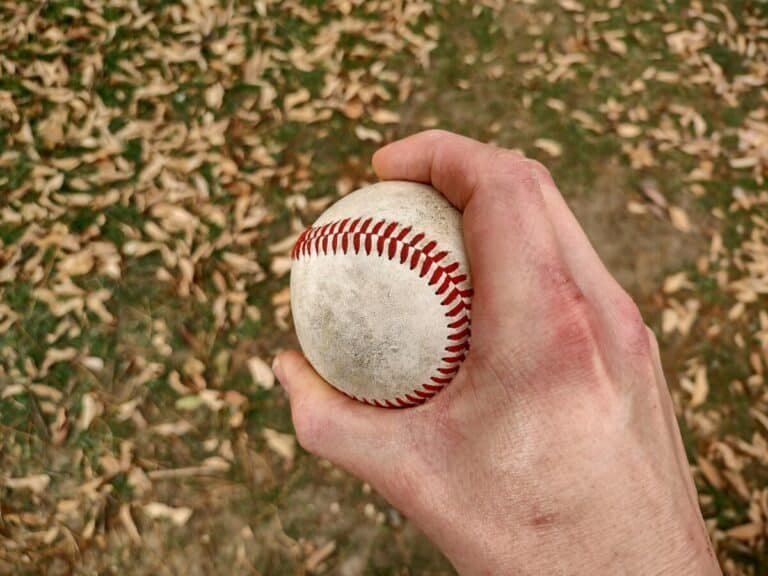 Overhead view of a hand holding a baseball demonstrating how to grip a curveball