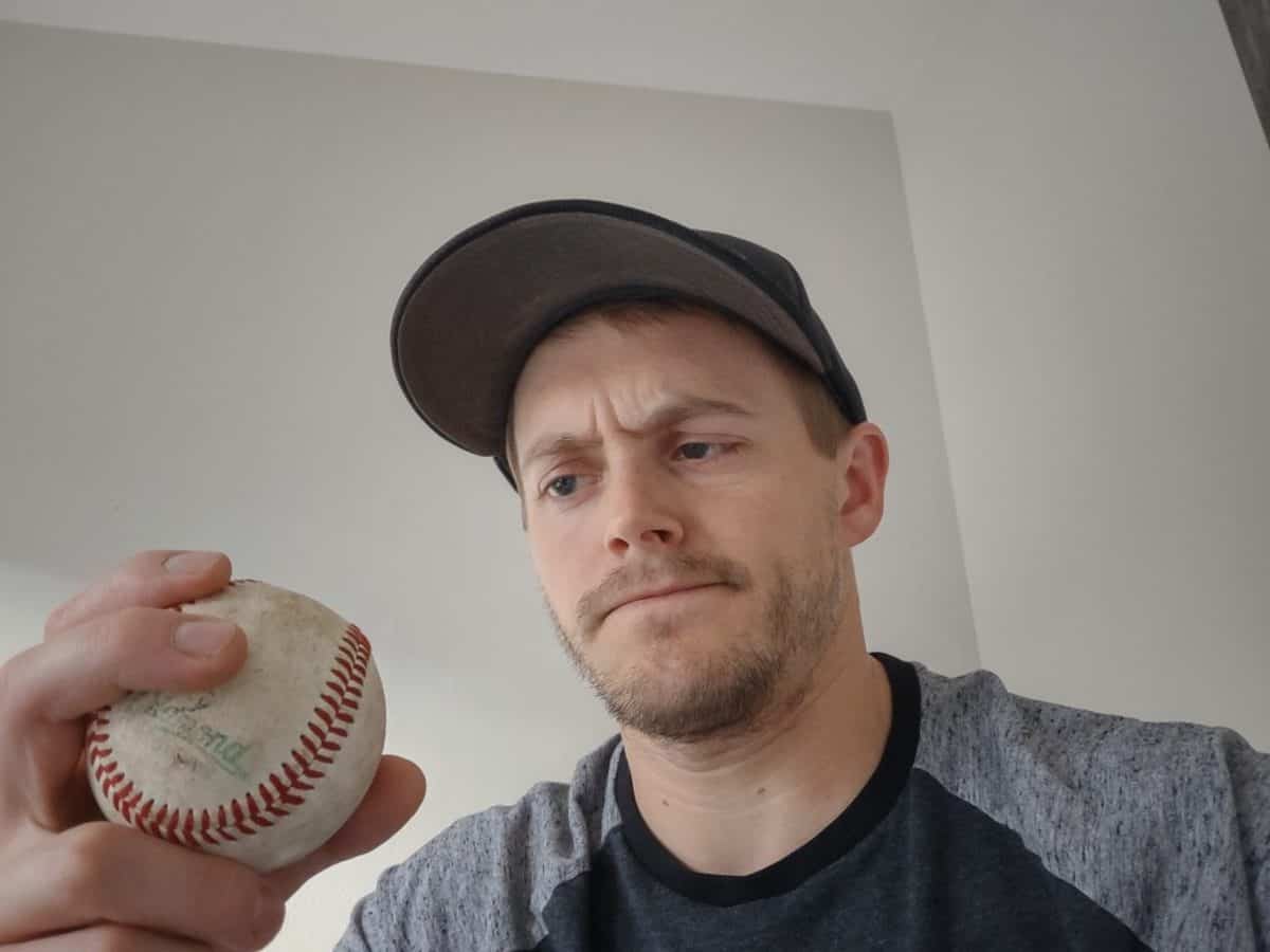 Man Wondering How to Pitch Baseball