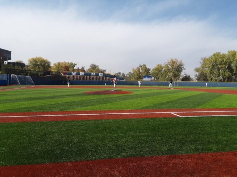 Baseball game being played on an all-turf baseball field