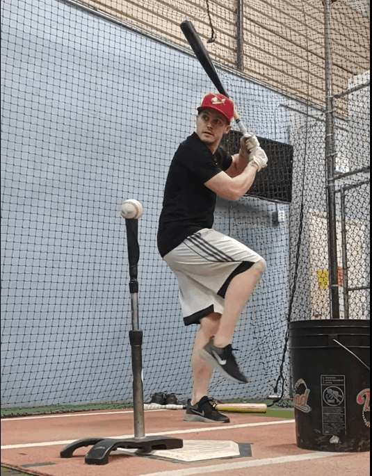 Steve Nelson taking batting practice using a batting tee