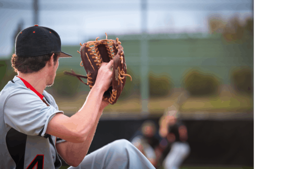 The back of a pitcher's head who is winding up. The batter, umpire, and catcher are blurry in the background