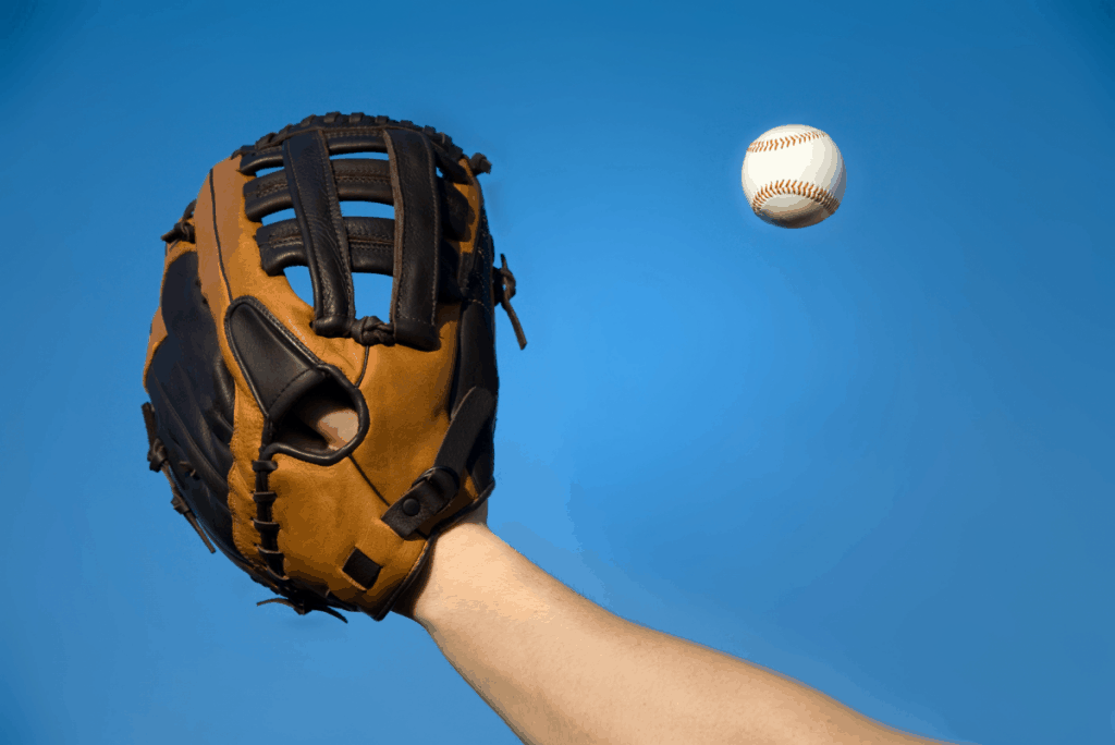 Looking up at a player's fielding glove, reaching for the fly ball