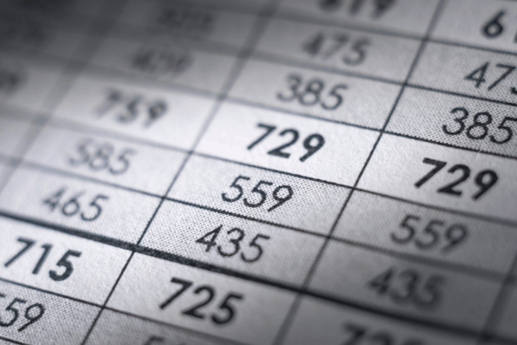 Closeup of three-digit numbers listed on a paper spreadsheet
