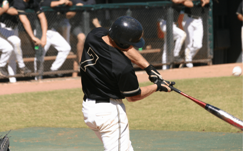 Hitter wearing number 7 making contact with the pitch