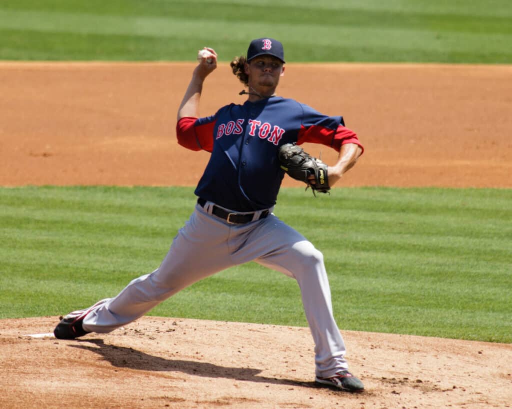 Boston Red Sox pitcher on the mound in the middle of his delivery