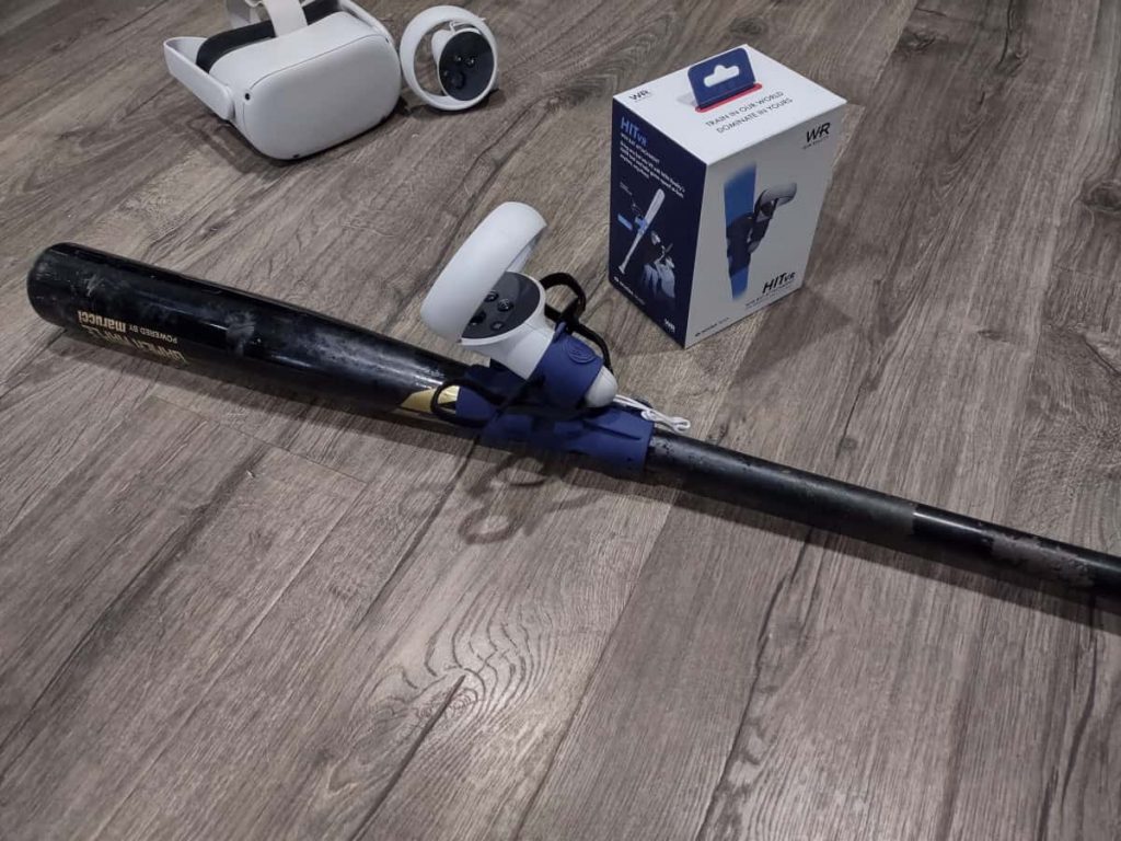 Baseball bat laying on a wood floor with the WIN Reality bat attachment installed