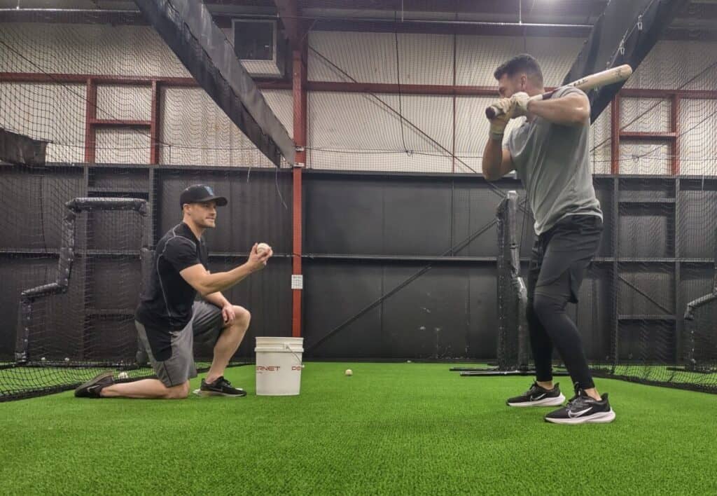 Pitcher showing the ball to the hitter for soft toss drill
