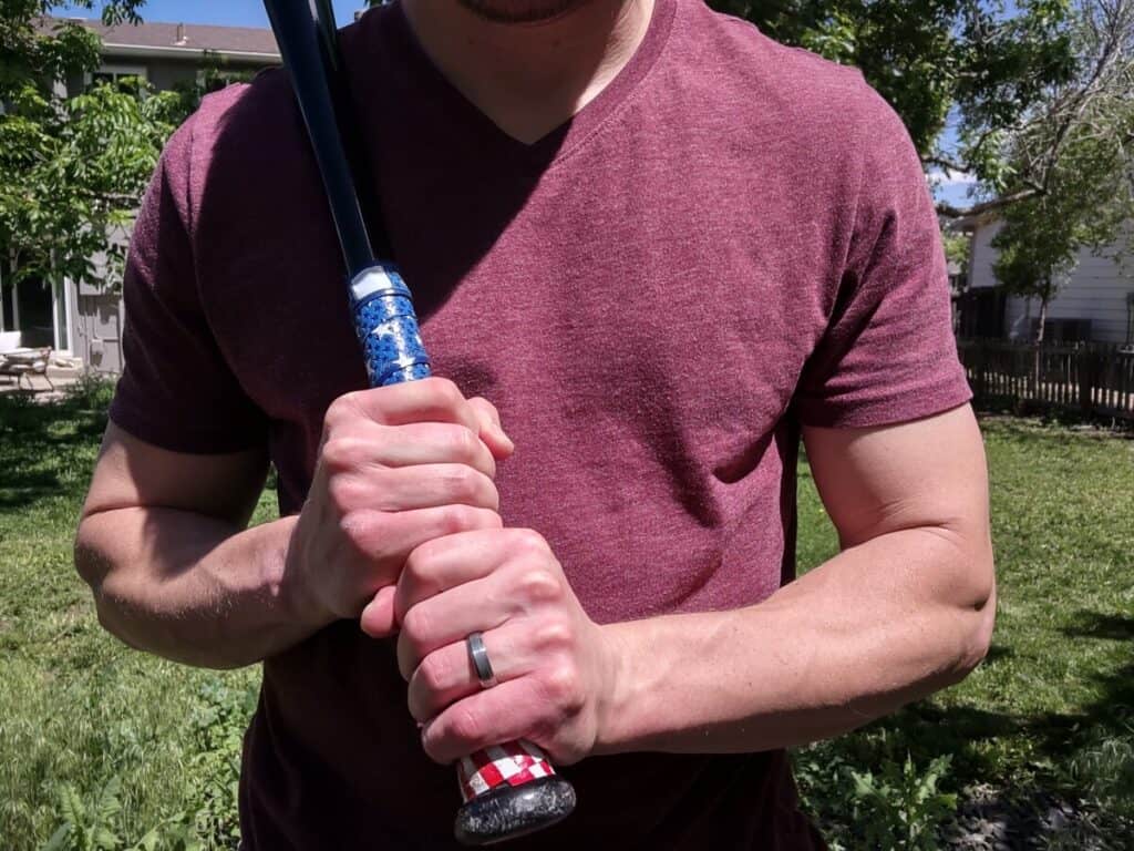 Demonstrating how to hold a baseball bat for right-handed players