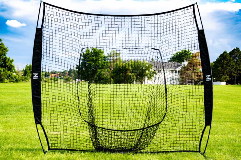 Zelus hitting net set up in an open grassy area