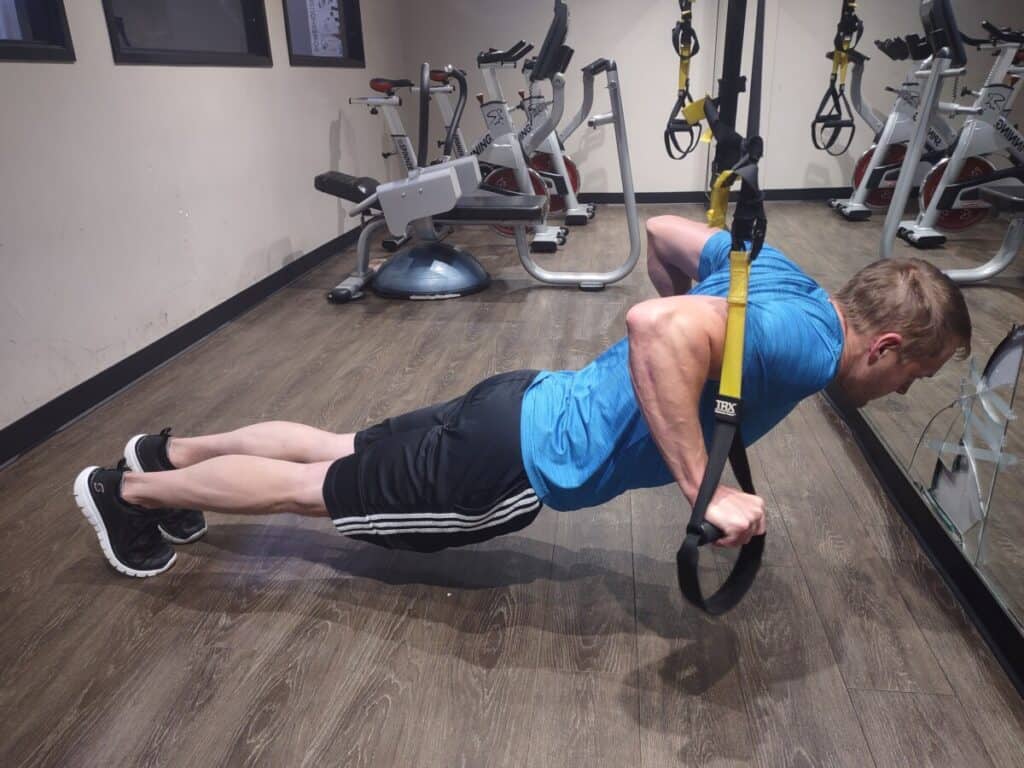 Steve Nelson at the concentric phase of a pushup while using TRX bands